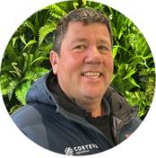 A person smiling in front of plants

AI-generated content may be incorrect.